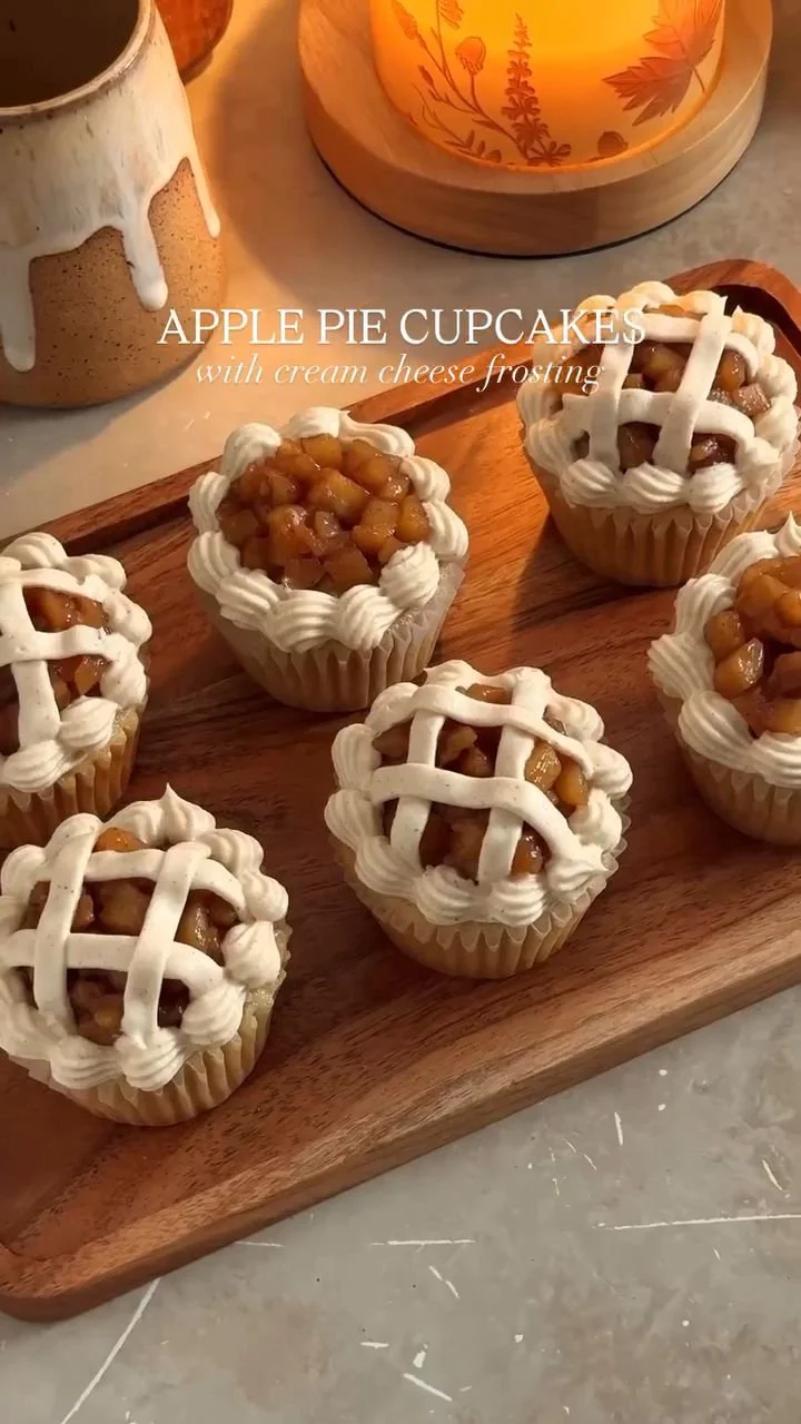 Delicious apple pie cupcakes topped with creamy frosting and spiced apple filling.