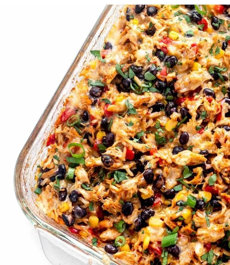 Delicious Chicken Burrito Casserole topped with cheese and fresh ingredients