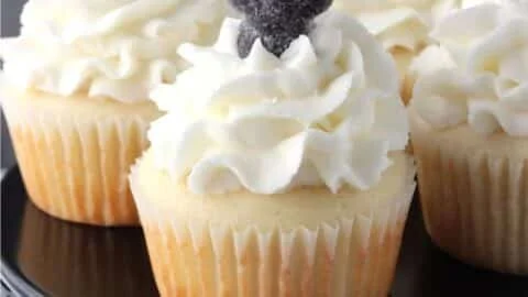 Anise licorice cupcakes decorated with frosting and colorful sprinkles