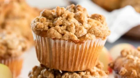 Freshly baked apple crumble muffins with crumbly topping and apple chunks