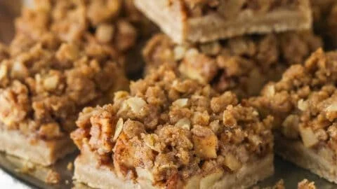 Apple pie bars topped with cinnamon and sugar in a baking dish