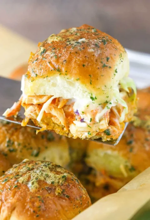 Baked Buffalo Chicken Sliders served with a side of ranch dressing