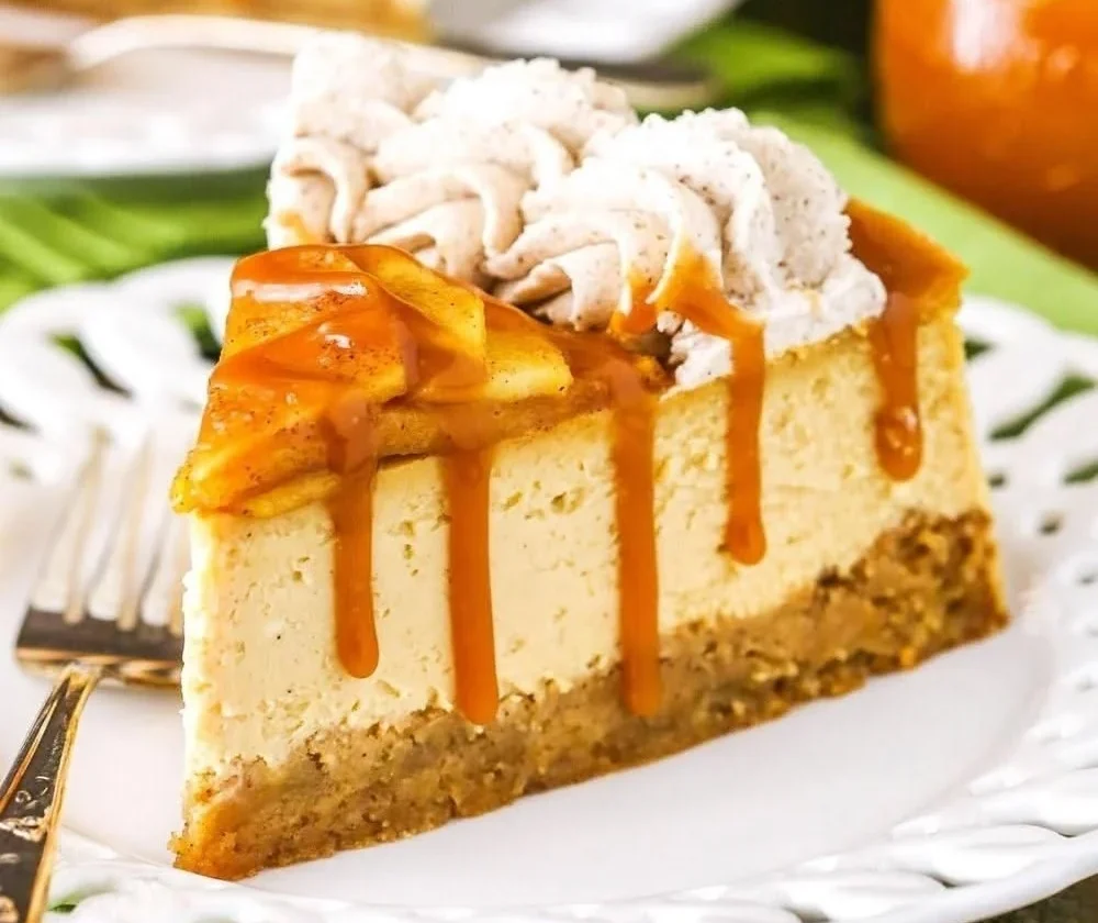 Delicious Caramel Apple Blondie Cheesecake topped with caramel sauce and apples