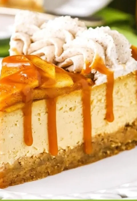 Delicious Caramel Apple Blondie Cheesecake topped with caramel sauce and apples