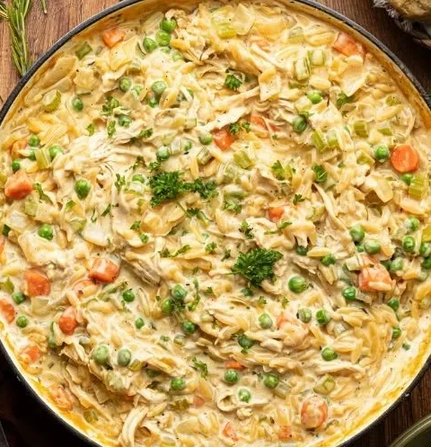 Delicious Chicken Pot Pie with Orzo topped with flaky pastry and fresh herbs.