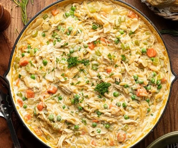 Delicious Chicken Pot Pie with Orzo topped with flaky pastry and fresh herbs.