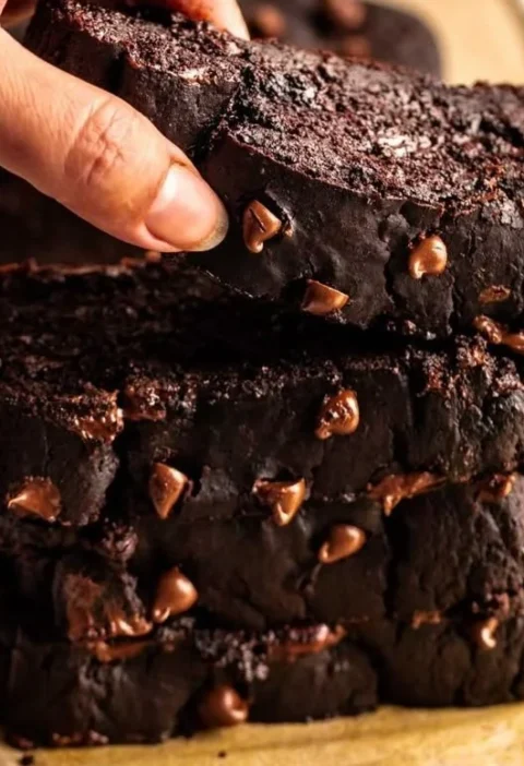 Loaf of delicious chocolate pumpkin bread with chocolate drizzle and pumpkin seeds