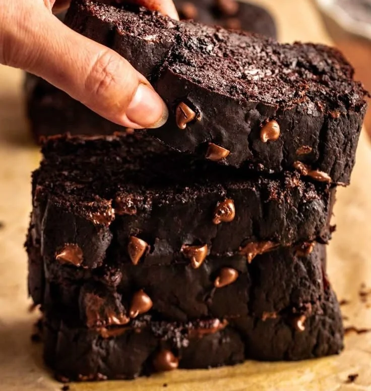 Loaf of delicious chocolate pumpkin bread with chocolate drizzle and pumpkin seeds