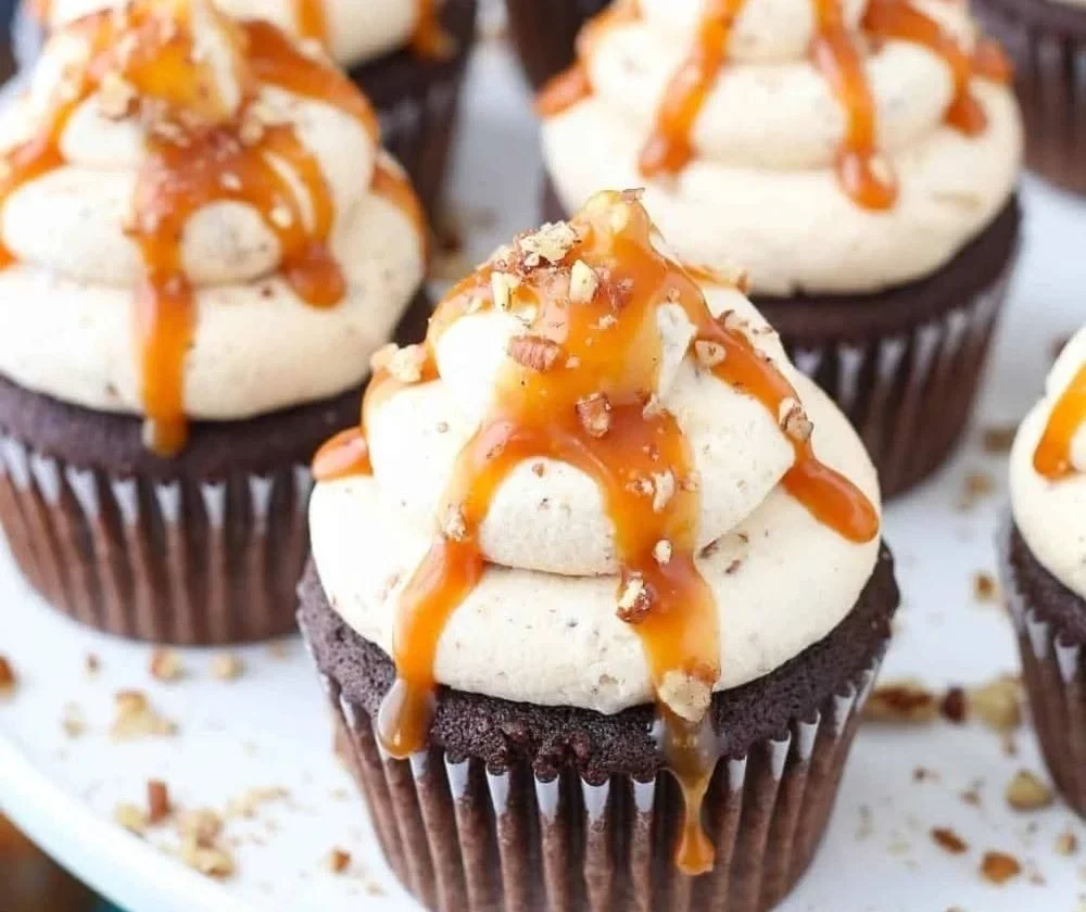 Delicious Chocolate Turtle Cupcakes topped with caramel and pecans.