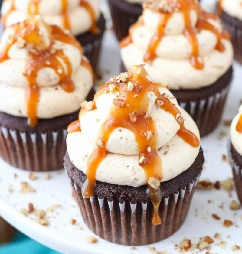 Delicious Chocolate Turtle Cupcakes topped with caramel and pecans.