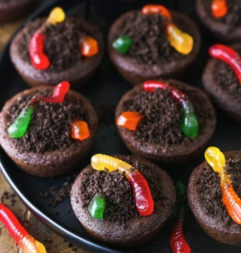 Delicious dirt cups cookies displayed on a plate with chocolate and cookie crumbles.