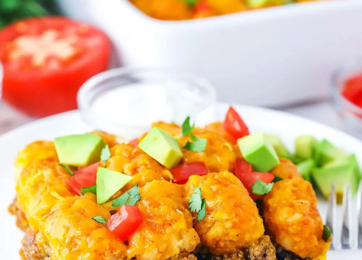 Delicious taco tater tot casserole baked to perfection with toppings.