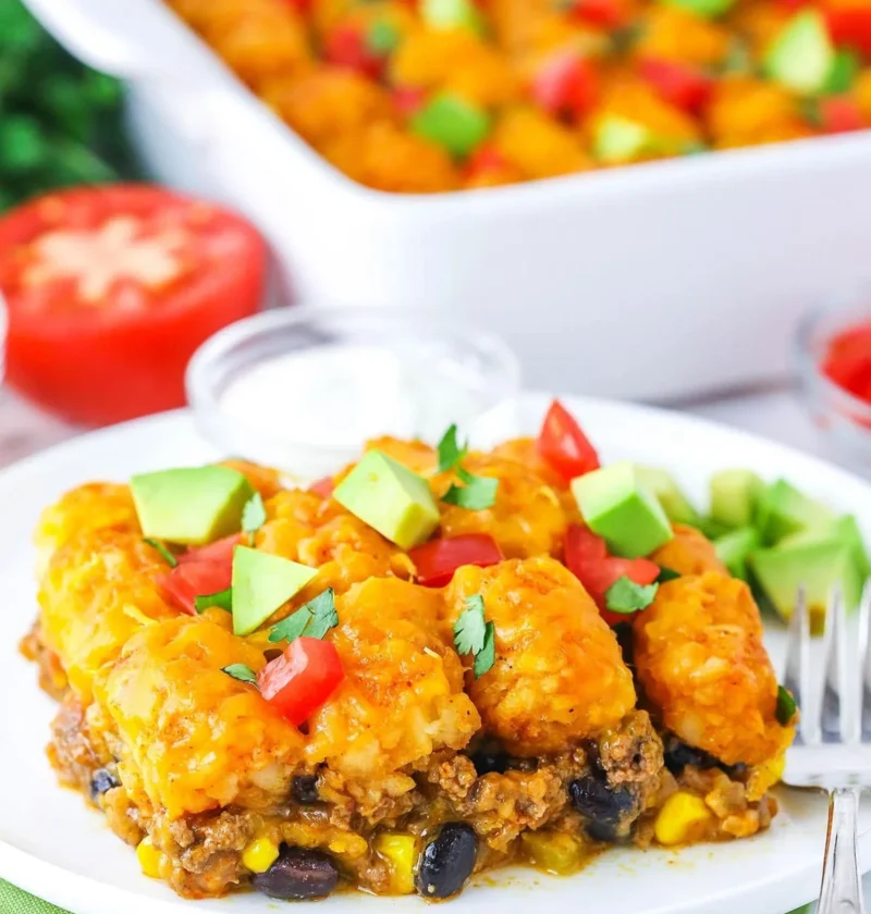 Delicious taco tater tot casserole baked to perfection with toppings.