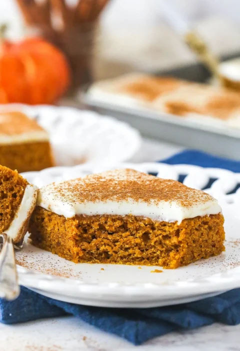 Delicious homemade pumpkin bars topped with cream cheese frosting.