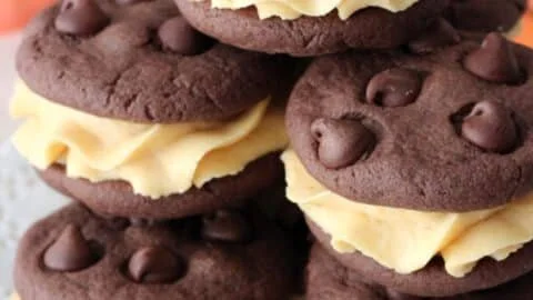 Pumpkin chocolate chip cookie sandwiches stacked with creamy filling