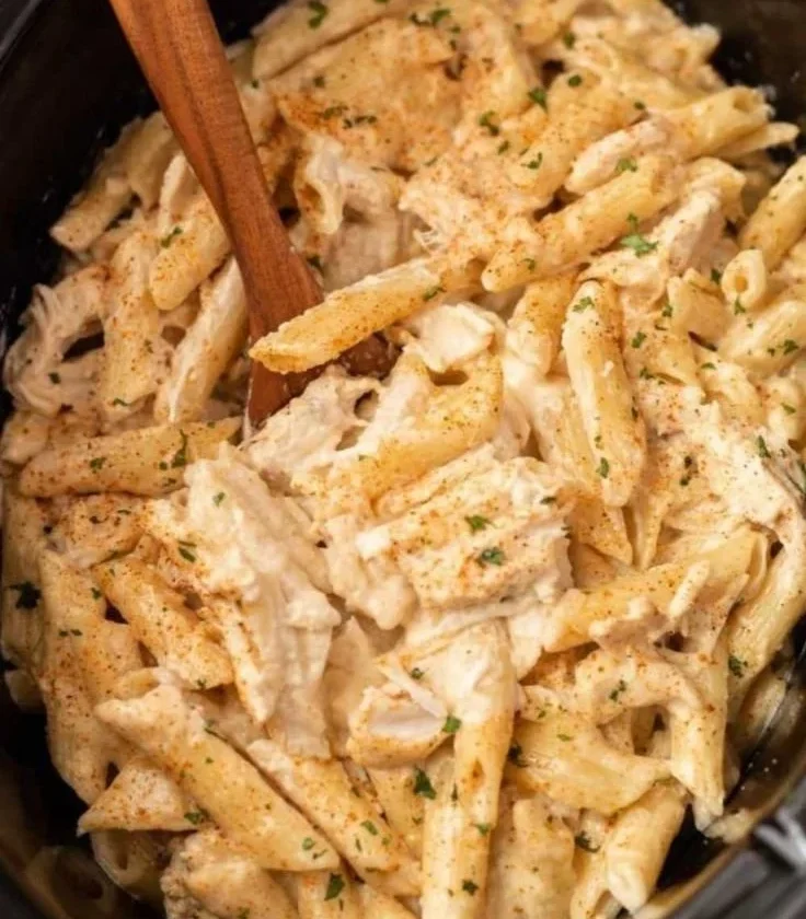 Bowl of Slow Cooker Cajun Chicken Pasta with herbs and spices
