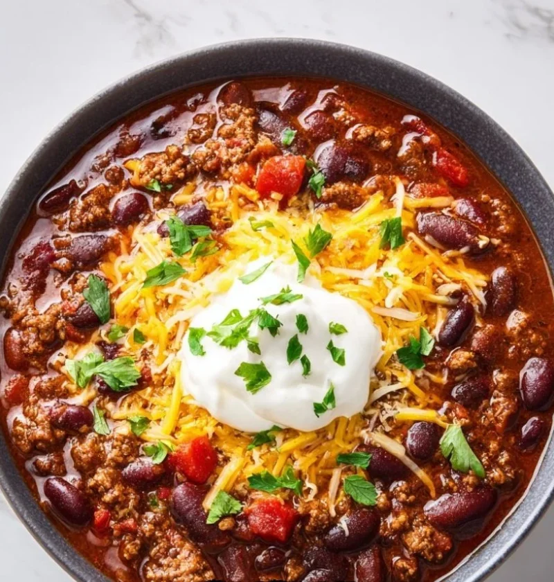 Hearty slow cooker chili simmering in a pot, perfect for family meals.