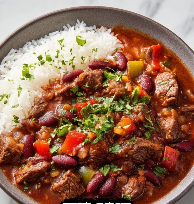 Bowl of hearty Steak Chili with Beans topped with fresh herbs