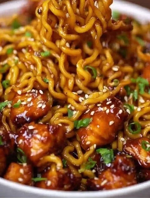 Delicious sticky garlic chicken noodles served in a bowl