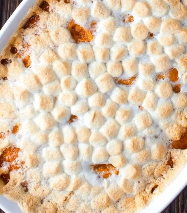 Delicious sweet potato casserole topped with marshmallows and pecans