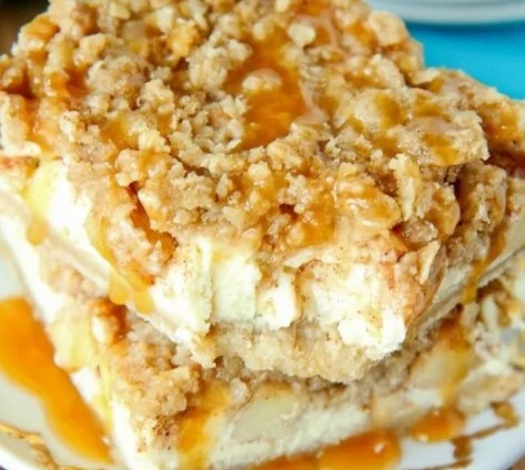 Delicious Apple Pie Cheesecake Bars on a rustic wooden table