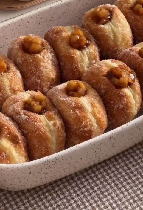 Homemade Apple Pie Donuts topped with cinnamon sugar and apple pieces