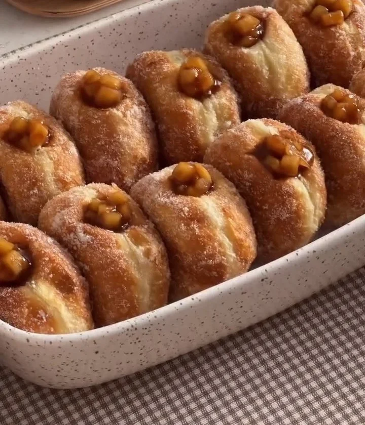 Homemade Apple Pie Donuts topped with cinnamon sugar and apple pieces
