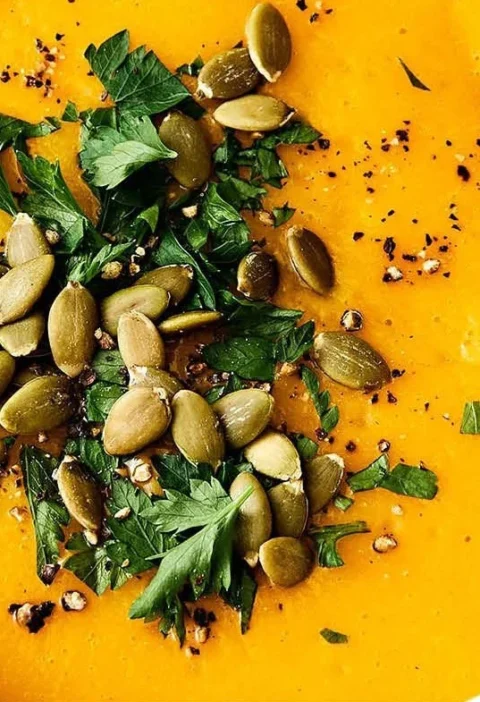 Delicious bowl of homemade butternut squash soup garnished with herbs