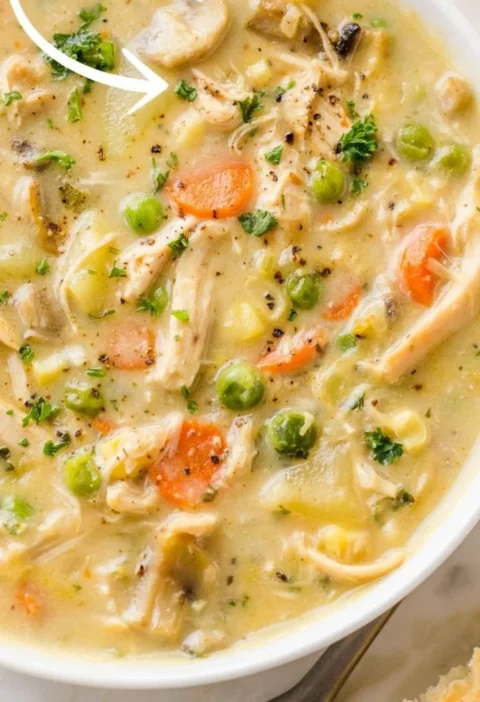 Delicious bowl of chicken pot pie soup topped with herbs