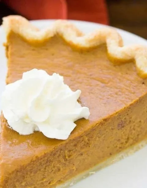 Slice of best homemade pumpkin pie, perfect for Thanksgiving 2020