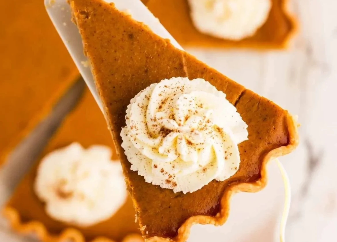 Delicious homemade pumpkin pie with whipped cream topping
