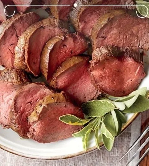 A beautifully arranged Christmas dinner table featuring various festive dishes.