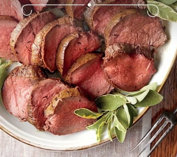 A beautifully arranged Christmas dinner table featuring various festive dishes.