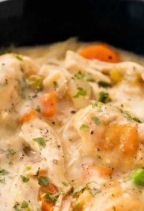 Creamy crockpot chicken and dumplings served in a cozy bowl