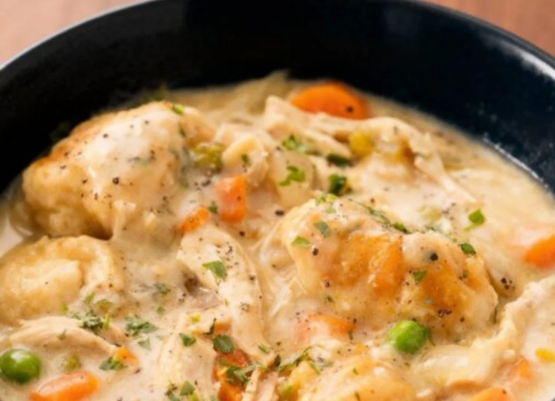 Creamy crockpot chicken and dumplings served in a cozy bowl