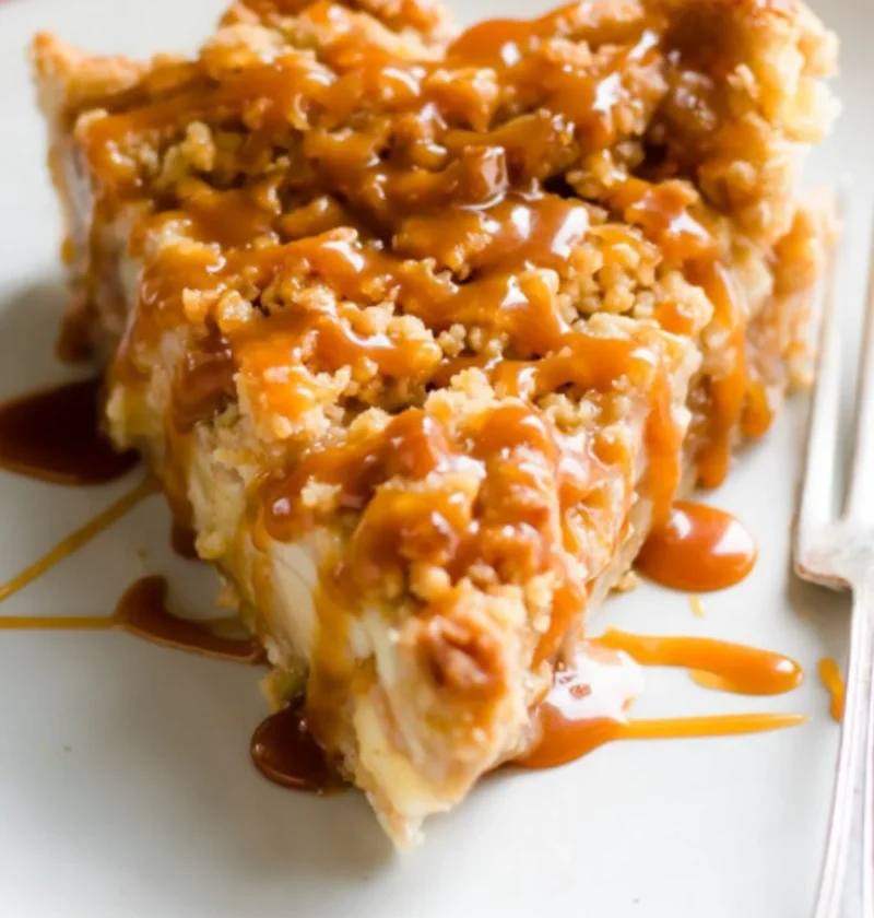 Slice of Dutch caramel apple pie with caramel drizzle