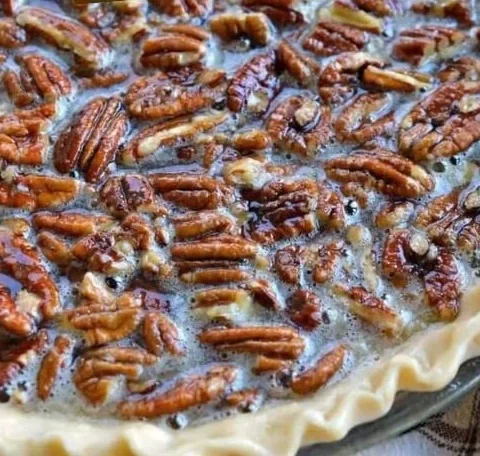 Slice of easy Southern pecan pie with a flaky crust and delicious filling