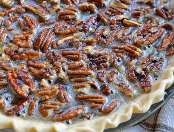 Slice of easy Southern pecan pie with a flaky crust and delicious filling