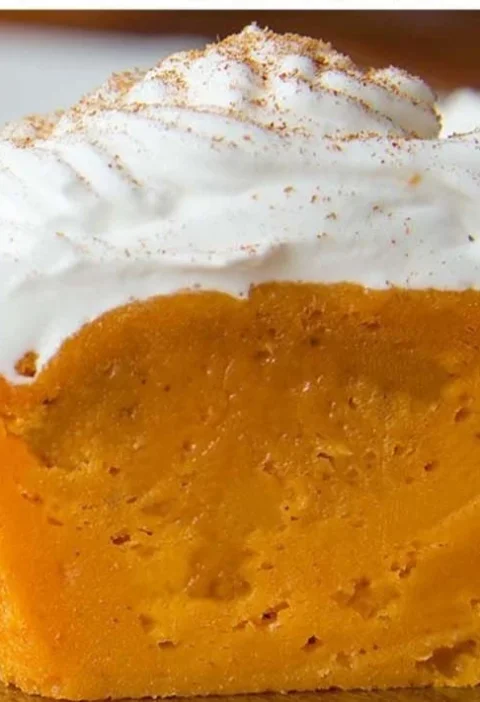 Photo of delicious Impossible Pumpkin Pie Cupcakes topped with whipped cream