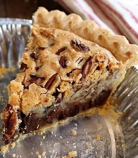 Delicious slice of Kentucky Pecan Pie topped with pecans and caramel glaze