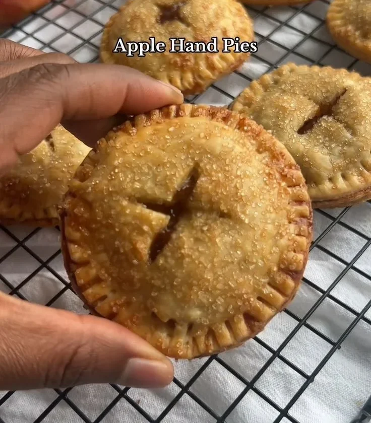Mini apple pies freshly baked with sweet apple filling and golden crust.