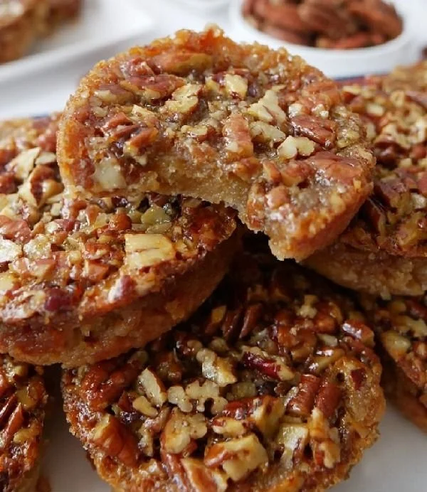 Mini pecan pies freshly baked, served on a plate for an inviting dessert option