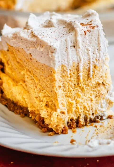 Delicious Pumpkin Mousse Pie topped with whipped cream and autumn spices