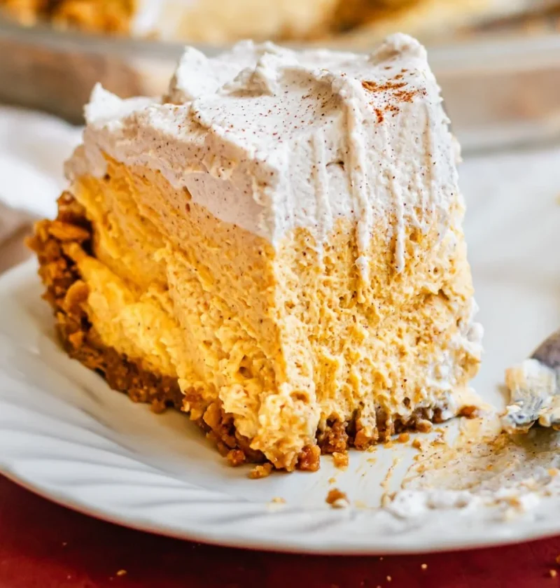 Delicious Pumpkin Mousse Pie topped with whipped cream and autumn spices