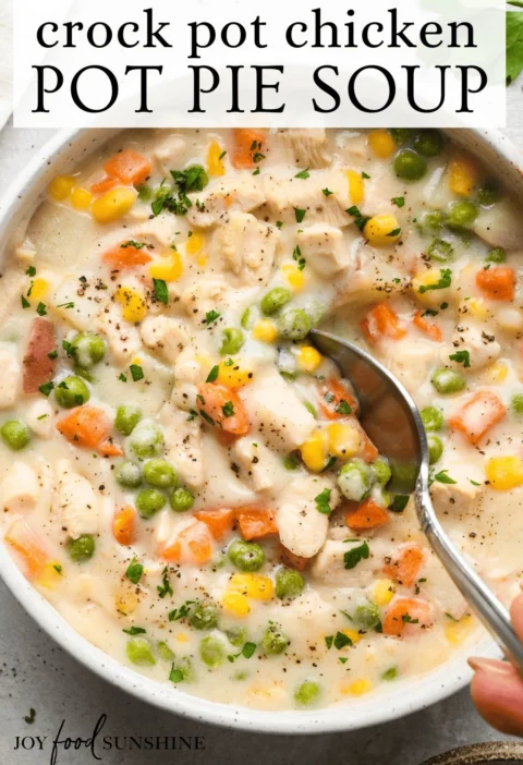 Slow Cooker Chicken Pot Pie Soup topped with fresh herbs in a bowl