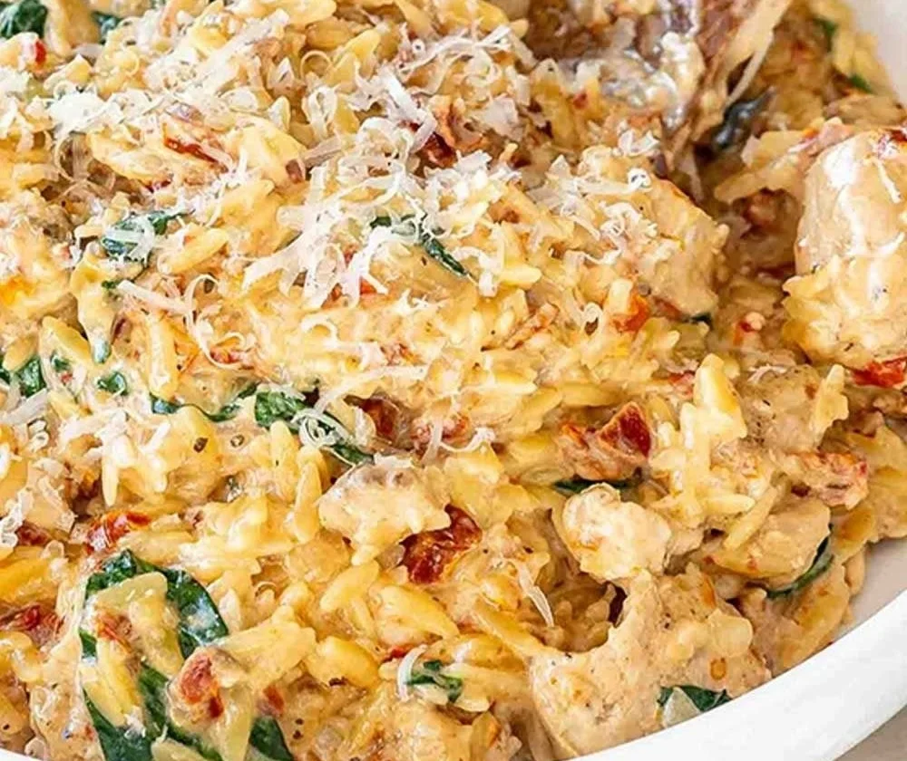 Delicious Slow Cooker Creamy Tuscan Chicken Orzo with fresh herbs and creamy sauce