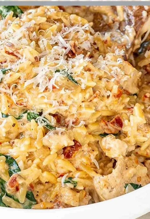 Delicious Slow Cooker Creamy Tuscan Chicken Orzo with fresh herbs and creamy sauce