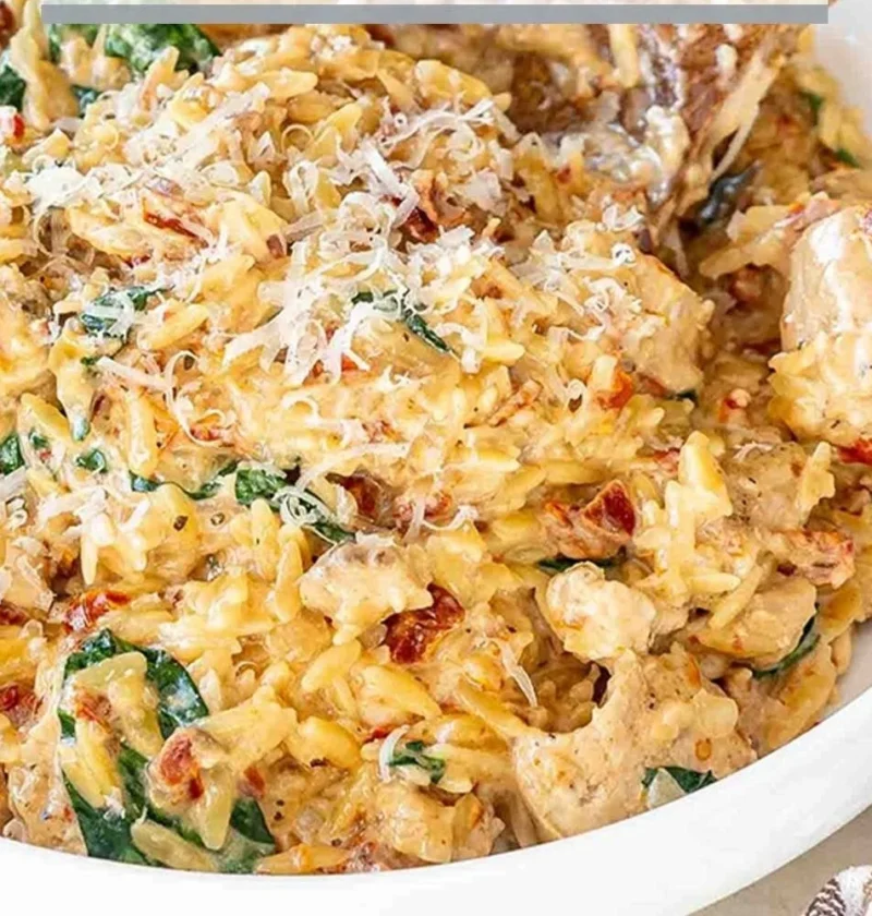 Delicious Slow Cooker Creamy Tuscan Chicken Orzo with fresh herbs and creamy sauce