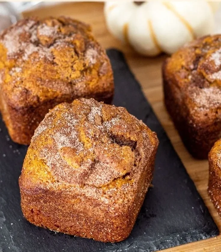 Slice of small batch cinnamon swirl pumpkin bread on a wooden board