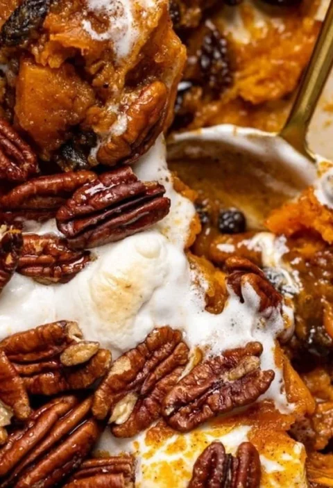 Southern Maple Sweet Potato Casserole topped with pecans and maple syrup.
